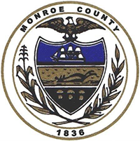 Seal of Monroe County featuring an eagle, ship, and laurel leaves, established in 1836.